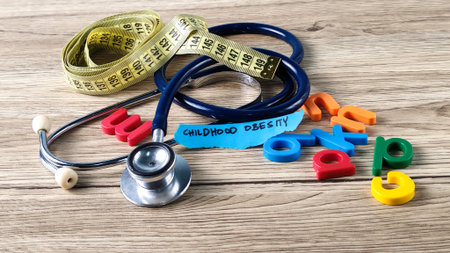 Childhood Obesity Medical Checkup Concept with Stethoscope and Measuring Tape on Wooden Background for Pediatric Healthの写真素材