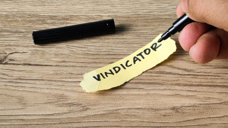 Vindicator concept being handwritten on a yellow sticky note with a black marker, symbolizing legal...
