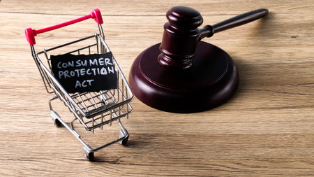 Consumer Protection Act concept with a judge's gavel and a miniature shopping cart, symbolizing buyer rights and legal regulation in commerce.の写真素材