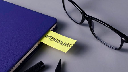 Amendments Note in Blue Notebook with Glasses: Legal Change, Policy Review, and Editing Conceptの写真素材
