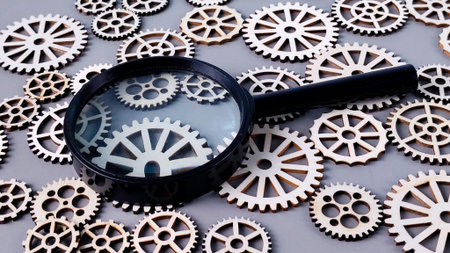 Magnifying Glass Focusing on Gears: Detailed Mechanical Analysis, Inspection, and Complex System Researchの写真素材