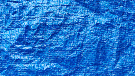 Bright Blue Woven Plastic Shopping Bag Texture Background with Wrinkled Crinkled Surface and Visible...
