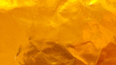 Vibrant Crumpled Gold Foil Texture Background with Wrinkles and Folds for Luxury Celebration and...