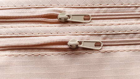 Double Beige Zippers on Ripstop Fabric with Stitched Seams and Horizontal Lines for Fashion, Sewing,...