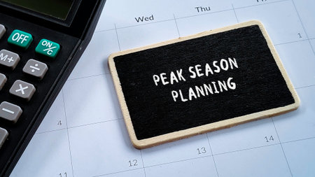 Peak Season Planning Concept on Chalkboard with Calculator and Calendar Background