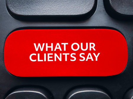 What Our Clients Say text on red keyboard button for customer feedback and testimonial review conceptの写真素材