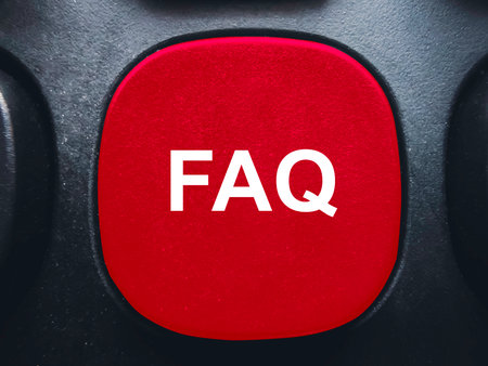 Red FAQ button on a black computer keyboard for help and frequently asked questions supportの写真素材