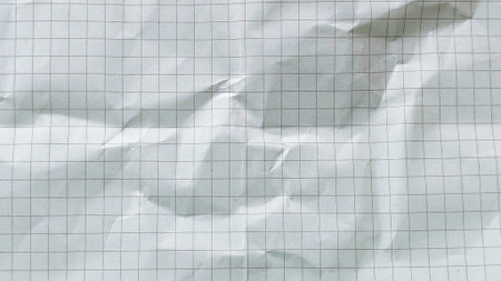 Crumpled white grid paper texture background with realistic folds and square pattern detailの写真素材