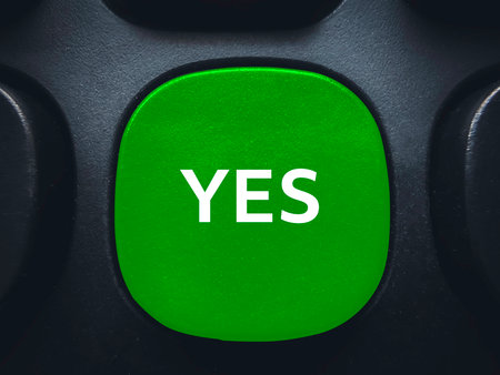 Green yes button on computer keyboard for positive confirmation agreement and successful decision makingの写真素材