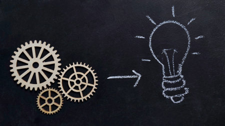 Creative Thinking and Problem Solving Concept with Wooden Gears and Hand Drawn Light Bulb on Blackboardの写真素材