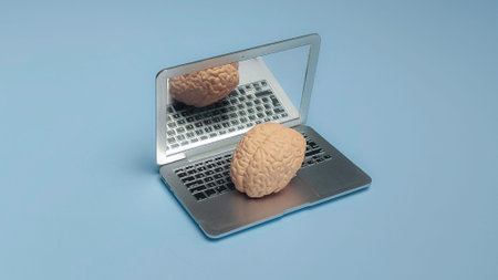 Human Brain Model Resting on a Laptop Keyboard Representing Artificial Intelligence Machine Learning...