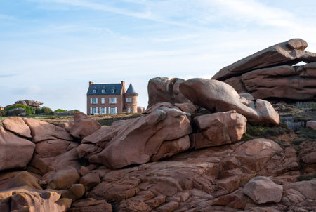 Pink granite rocks with mansion in the backgroundの写真素材