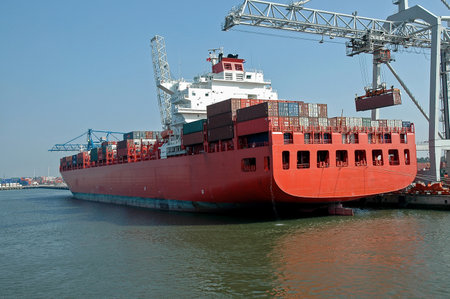 Loading a red container shipの写真素材