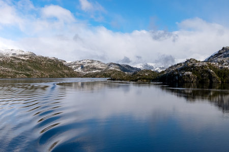 Patagonian snow capped mountains seen from the pacific oceanの写真素材