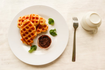 Croissant Waffle or Croffle with chocolate sauce served in box and white backgroundの写真素材