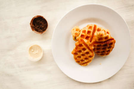 Croissant Waffle or Croffle with chocolate sauce served in box and white backgroundの写真素材