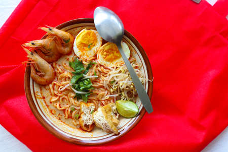 laksa, laksa curry made from vermicelli, noodles, bean sprouts, egg, tofu lime, and shrimp with a...