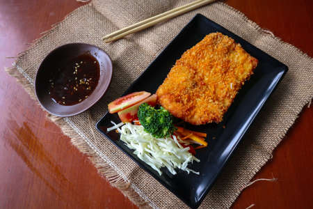chicken katsu don is japanese food served with soy sauce on table