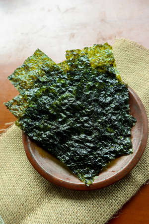 nori seaweed isolated on white background. Japanese food nori. Dry seaweed sheets.