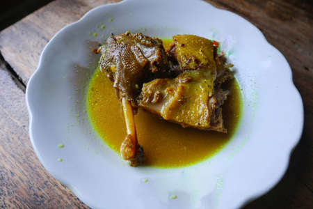 "duck curry or opor bebek served plate on wood background.
asia food"の写真素材