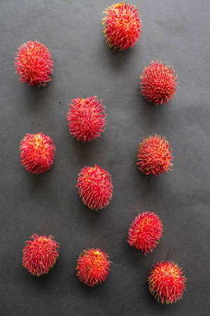 rambutan, sweet red rambutan fruit isolated on black backgroundの写真素材