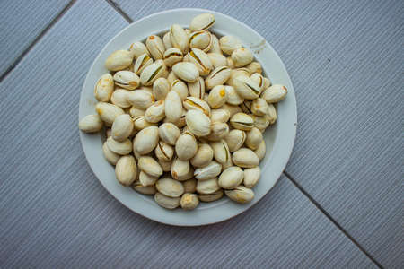 Pistachio nuts in white plate isolated on white background.
Pistachio nuts with rectangular shapeの写真素材