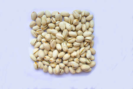 Pistachio nuts in white plate isolated on white background.
Pistachio nuts with rectangular shape
