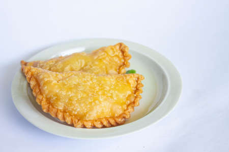 pastie cake or pastry cake or kue pastel served with green chili in little plate on wood...