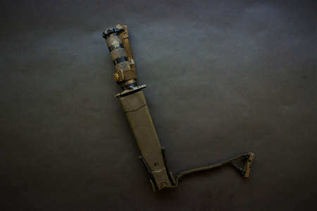 black military knife on black background