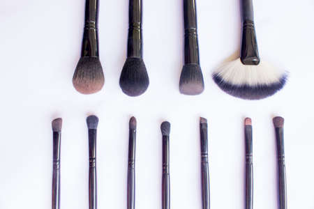 makeup brushes set isolated on white background. Top view, flat lay