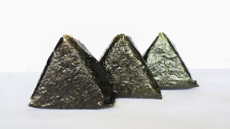 Onigiri is Japanese food, Japanese rice ball, rice triangle with seaweed, nori isolated on with...