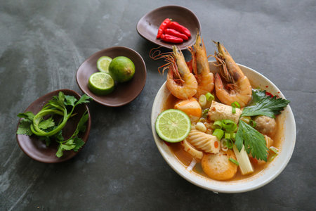 Tom yam soup originating from Thailand. Tom yum is made with shrimp, chili, lime, chicken, fish, or seafood and mushrooms.の写真素材