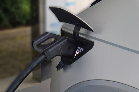 EV Car or Electric car at charging station with the power cable supply plugged