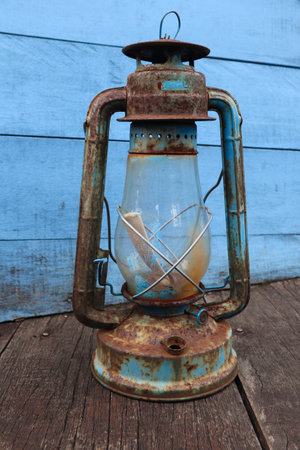 antique petromak lamp (teplok) which still uses kerosene fuel on wood backgroundの写真素材