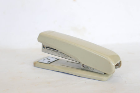white stapler isolated on a white background.の写真素材