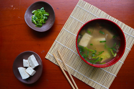 miso soup or Japanese miso soup in bowl on the table. Japanese cuisine in the form of soup with dashi ingredients, tofu, seafood, vegetables, and topped with miso to tasteの写真素材
