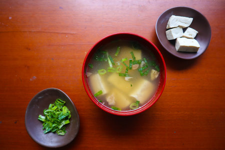miso soup or Japanese miso soup in bowl on the table. Japanese cuisine in the form of soup with dashi ingredients, tofu, seafood, vegetables, and topped with miso to tasteの写真素材