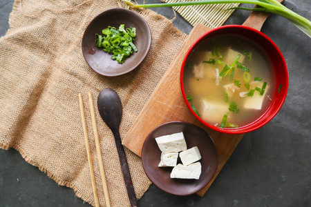 miso soup or Japanese miso soup in bowl on the table. Japanese cuisine in the form of soup with dashi ingredients, tofu, seafood, vegetables, and topped with miso to tasteの写真素材