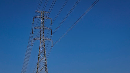 the pylon outline, Very High Voltage Power Lines (Indonesia : SUTET) on blue sky