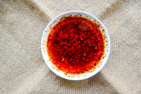 chilli oil. Homemade chilli oil in a glass liite plate, on tableの写真素材