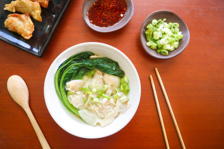 wonton soup. Bowl of wonton soup with chili oil. Shrimp or meat dumpling soup with mustard , green onions,の写真素材
