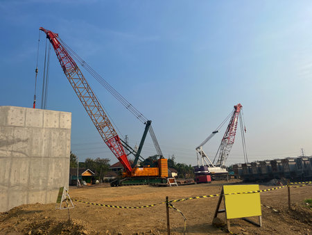 crawler crane. diesel electric yellow crawler crane at Large construction site including several...