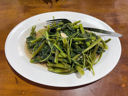 cah kangkung or Stir fried water spinach or Tumis kangkung served on table. asian indonesian foodの写真素材