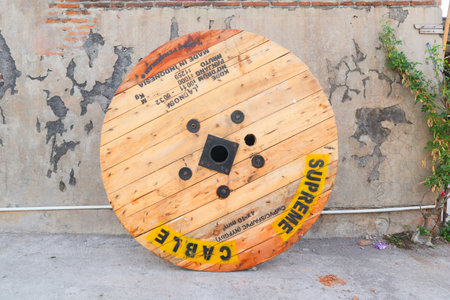 A large Wooden coils of electric cable, High and low voltage cables in the storage in factory.の写真素材