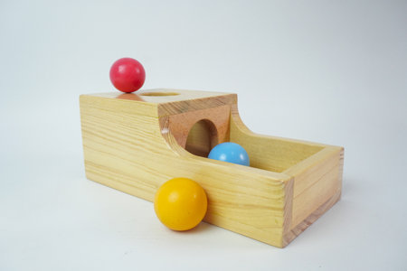 A wooden toy set with a wooden cylinder, ball, ring, isolated white backgroundの写真素材