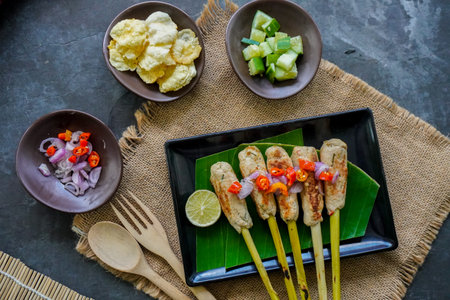 Sate lilit or satay lilit food from Bali, Indonesia. Sate can be made from fish, or chicken, beef,...