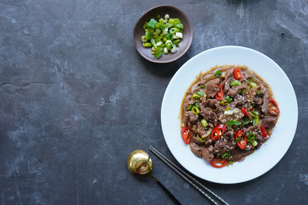Bulgogi is a Korean food made from beef grilled with sauce and spices. on black backgroundの写真素材