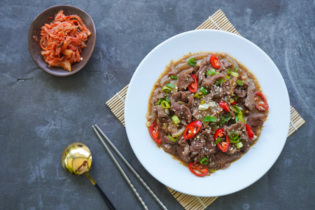 Bulgogi is a Korean food made from beef grilled with sauce and spices. on black backgroundの写真素材