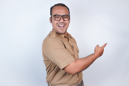 a man Asian civil servants or state civil servants is with brown uniform gesturing pointing at the...