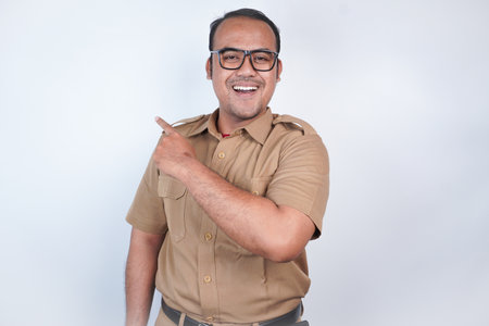 a man Asian civil servants or state civil servants is with brown uniform gesturing pointing at the...